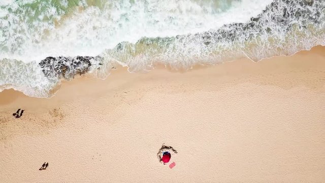 Beach and ocean during summer vacation day with tourists and people enjoying - beautiful aerial view of nature outdoors - tropical scenic travel concept in wild coasts