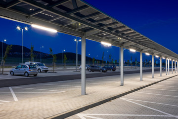 modern parking with covered pedestrian corridor at night