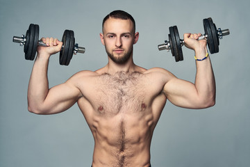 Fototapeta na wymiar Strong shirtless sport man with dumbbells isolated