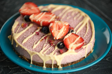Raw healthy vegan cheesecake, homemade with cashew, mint and strawberries
