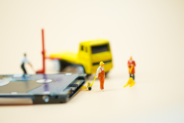 Miniature people: Workers pulling a pallet truck with circuit board moving for sent to repair.