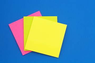 Many colorful paper stickers on blue background