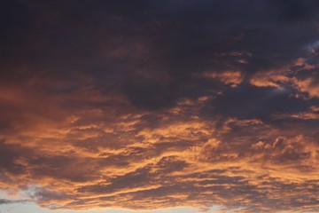 Naklejka na ściany i meble dark orange background color - cloudy sky structure at sunset