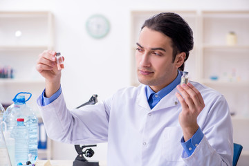 Young male chemist experimenting in lab