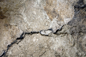 Big crack. A winding deep crack in an old stone wall. Copy space.