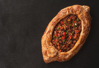 Traditional Turkish baked pide dish. Middle Eastern snacks. Turkish pizza. Pide with meat. Open meat pie. The view from the top. Copy space. - 278370768