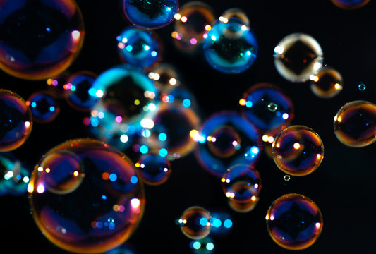 beautiful rainbow colorful of soap bubbles floating in the dark.
