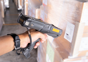 worker is scanning barcode scanner with cargo shipment.