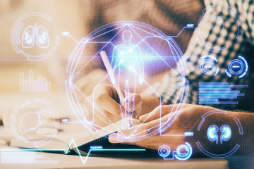 Man's hands working with notes background. Modern computer record diagram with virtual mnitor.