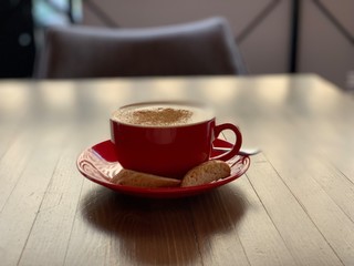 cup of coffee cuppuccino on wooden table
