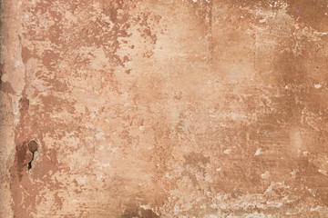 old shabby damaged plaster on the walls of houses close-up