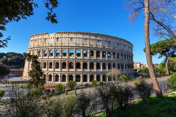 Ancient Italian monument of the Colosseum in Rome. View from the park.