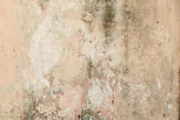 old shabby damaged plaster on the walls of houses close-up