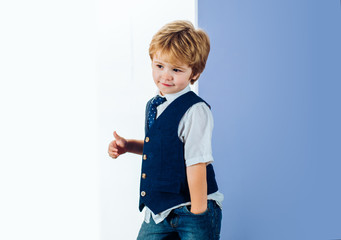 Cute boy with thumb up. Tie. Little gentleman. Male, style. Elegant man. Child denim fashion. Shy model. Attractive boy.