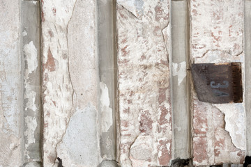old shabby damaged plaster on the walls of houses close-up