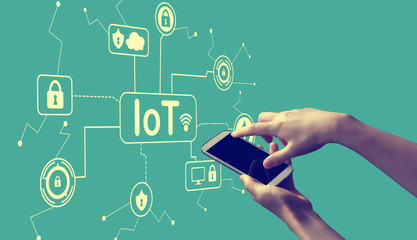 IoT security theme with person holding a white smartphone