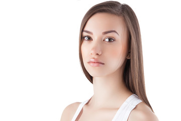 Attractive young woman on isolated white background. Closeup portrait of beautiful female looking at camera.