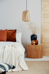 Wicker chandelier in classy bedroom interior in Scandinavian style