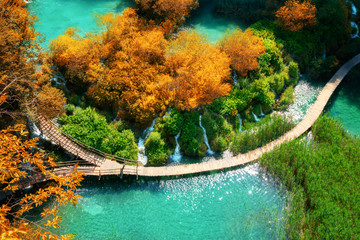 Beautiful wooden path trail for nature trekking with lakes and waterfall landscape in Plitvice Lakes National Park, UNESCO natural world heritage and famous travel destination of Croatia. © InfiniteFlow