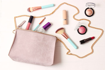 women's bag and cosmetics on a colored background