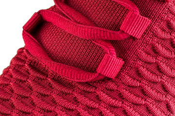Fragment of red sneakers with laces close up. Sneaker texture