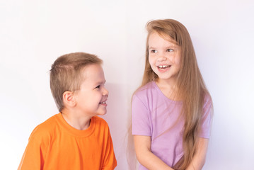 Cute little boy and girl, fun, laughing, on a light background
