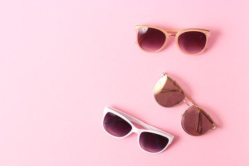 set of sunglasses on a colored background top view.