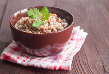 delicious buckwheat porridge in a bowl on a wooden table