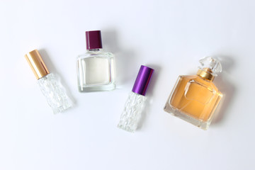 set of different perfumes on a light background top view.