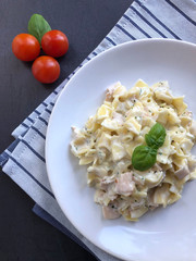 Austrian Ham Pasta specialty - Schinkenfleckerl - on metallic background.
