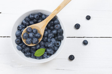Fresh blueberries isolated on white wooden table, view from the above