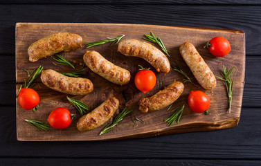 Grilled sausages with tomatoes , pepper and rosemary