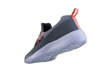 Gray sneaker with orange laces. Sport shoes on white background