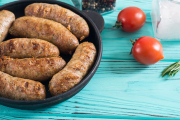 Grilled sausages with tomatoes , pepper and rosemary