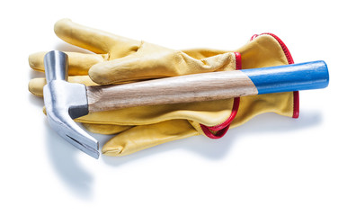 claw hammer on yellow  leather gloves isolated