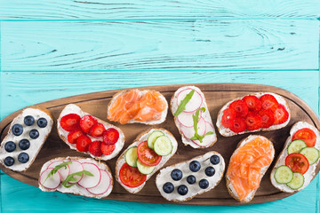 Variation of toast with fruit , vegetable and salmon