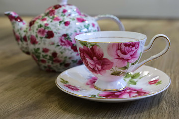 Antique floral tea set including tea pot, saucer and cup