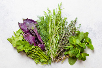 Dill, parsley, rosemary, mint, thyme and basil oon wooden board