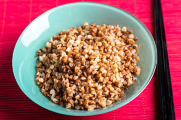 bowl full of buckwheat and chopsticks