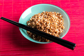 bowl full of buckwheat and chopsticks
