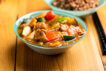 goulash with vegetables on wooden table