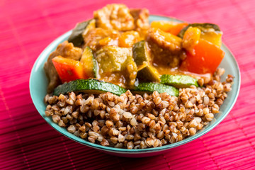 goulash with vegetables in a green bowl