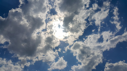 beautiful background of clouds, clearly visible lines of white clouds and blue sky, the top is a sunbeam
