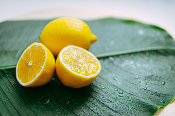 lemon cut in half on banana leaves