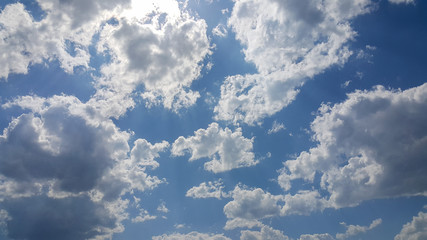 beautiful background of clouds, clearly visible lines of white clouds and blue sky, the top is a sunbeam
