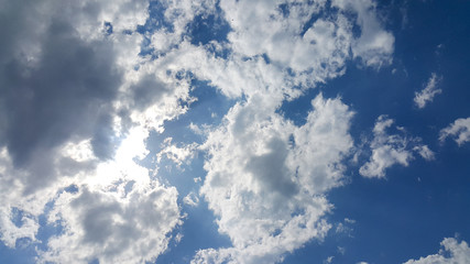 beautiful background of clouds, clearly visible lines of white clouds and blue sky, the top is a sunbeam