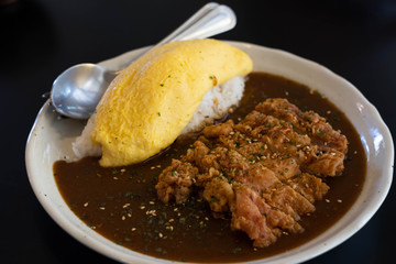 Japanese curry rice with fried chicken and omelet.
