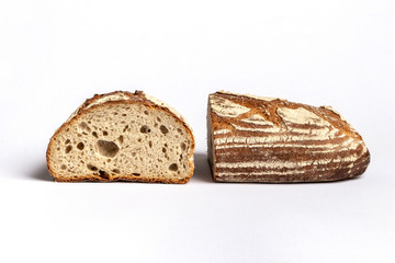 Fresh home-made bread with a crispy crust, on white background.