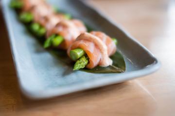 Salmon asparagus roll with spicy sauce, Japanese food. (selective focus point)