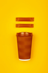 Brown paper coffee cup over yellow